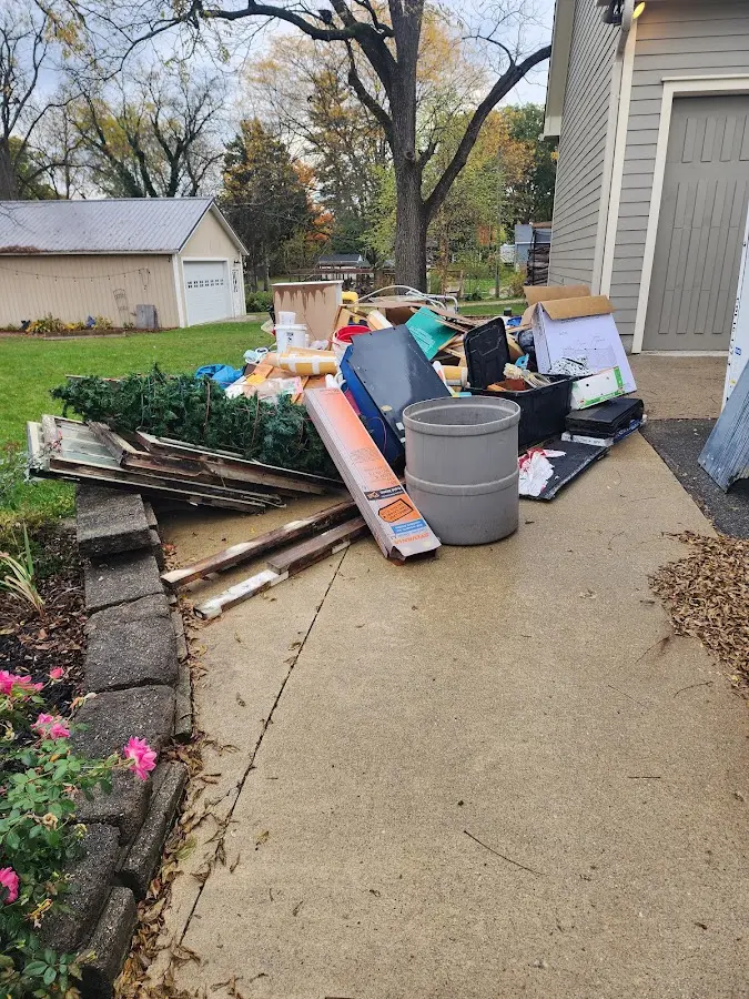 Dumpster being loaded with debris for Roofing Dumpster Rental in Ashwaubenon
